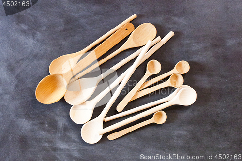 Image of Wooden spoons on blackboard background.