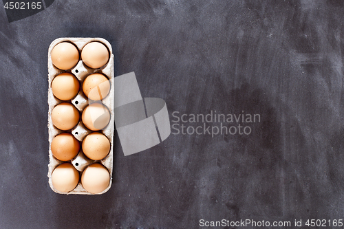 Image of Ten chicken eggs in cardboard container.