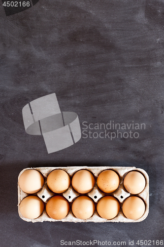 Image of Farm chicken eggs in cardboard container.