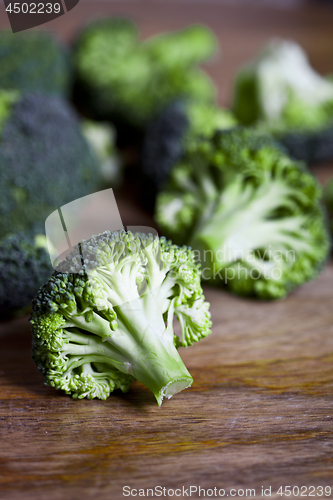 Image of Fresh green organic broccoli closeup on wooden table.
