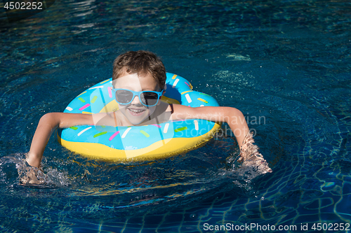 Image of One little happy boy  playing on the inflatable circle