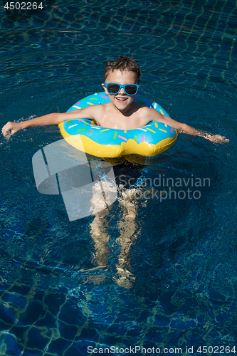 Image of One little happy boy  playing on the inflatable circle