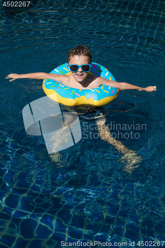 Image of One little happy boy  playing on the inflatable circle