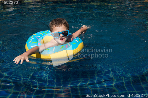 Image of One little happy boy  playing on the inflatable circle