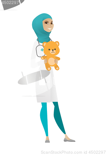 Image of Pediatrician doctor holding teddy bear.