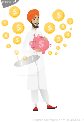 Image of Hindu businessman holding a piggy bank.