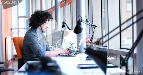 Image of businessman working using a laptop in startup office