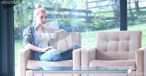 Image of woman drinking coffee enjoying relaxing lifestyle
