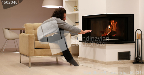 Image of young man at home reading book