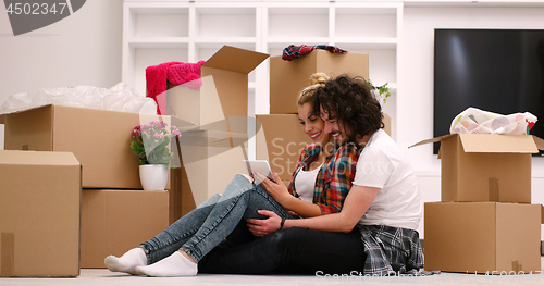 Image of young couple moving  in new house