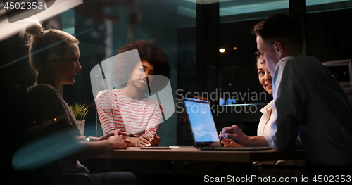 Image of Multiethnic startup business team in night office