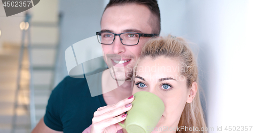 Image of young couple enjoying morning coffee
