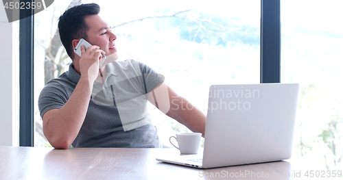 Image of businessman working using a laptop in startup office