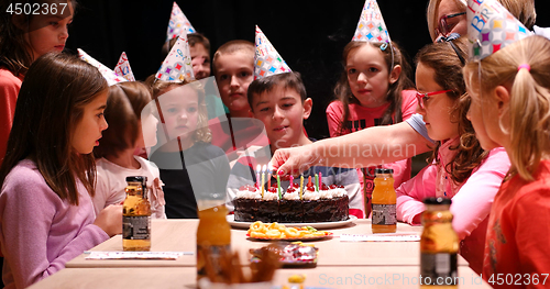 Image of The young boy joyfully celebrating his birthday