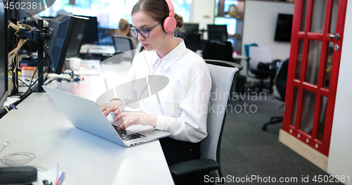 Image of businesswoman using a laptop in startup office
