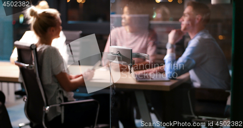 Image of Multiethnic startup business team in night office