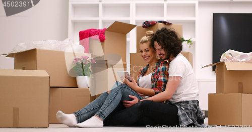 Image of young couple moving  in new house