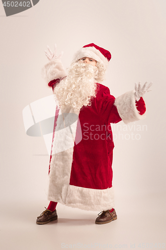 Image of The happy girl in santa claus costume at studio