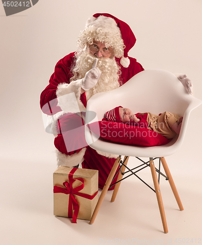 Image of Christmas portrait of cute little newborn baby girl, dressed in christmas clothes, studio shot, winter time