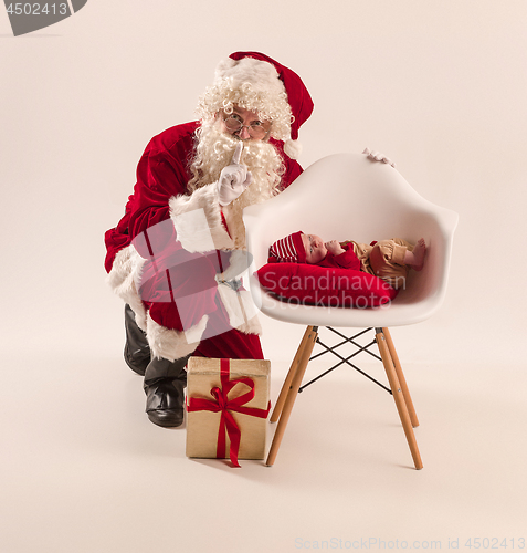 Image of Christmas portrait of cute little newborn baby girl, dressed in christmas clothes, studio shot, winter time