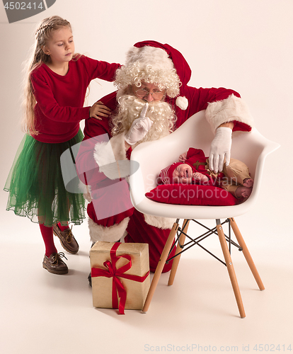 Image of Christmas portrait of cute little newborn baby girl, dressed in christmas clothes, studio shot, winter time