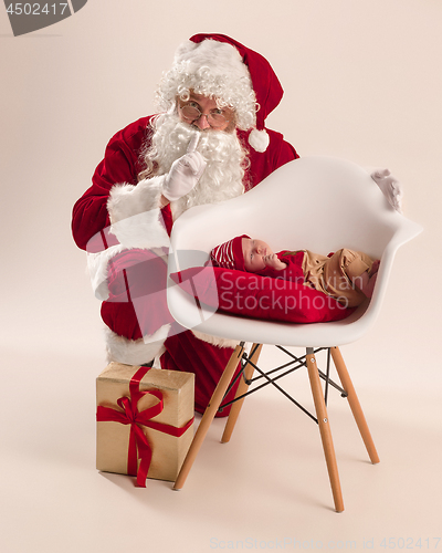 Image of Christmas portrait of cute little newborn baby girl, dressed in christmas clothes, studio shot, winter time