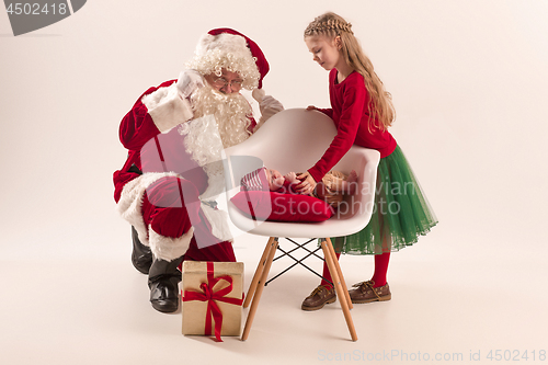 Image of Christmas portrait of cute little newborn baby girl, dressed in christmas clothes, studio shot, winter time