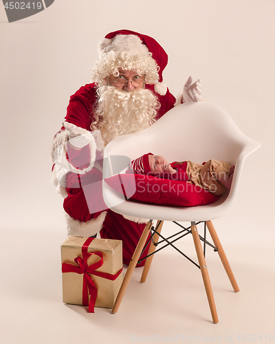 Image of Christmas portrait of cute little newborn baby girl, dressed in christmas clothes, studio shot, winter time