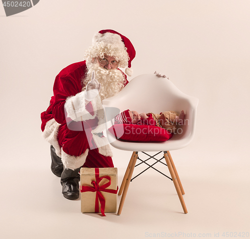 Image of Christmas portrait of cute little newborn baby girl, dressed in christmas clothes, studio shot, winter time