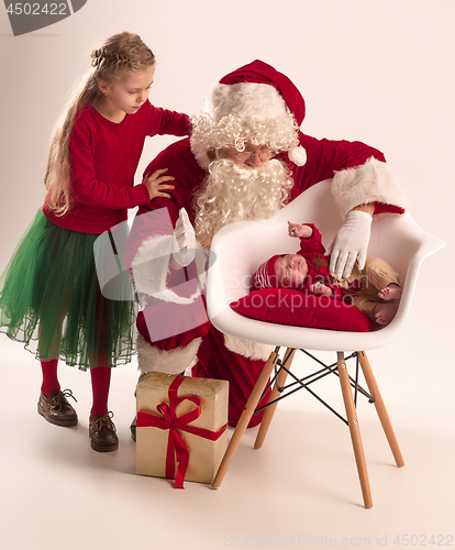 Image of Christmas portrait of cute little newborn baby girl, dressed in christmas clothes, studio shot, winter time