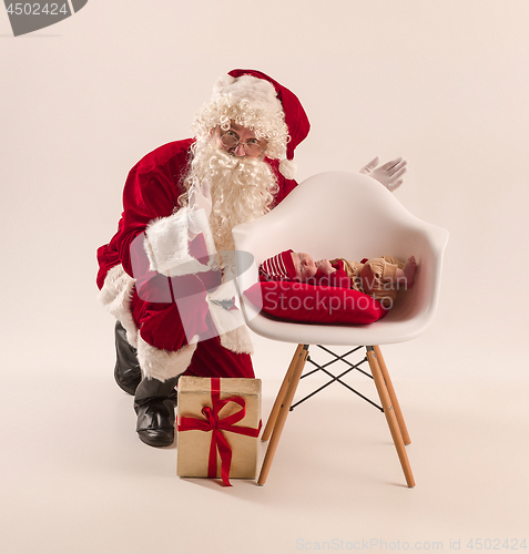 Image of Christmas portrait of cute little newborn baby girl, dressed in christmas clothes, studio shot, winter time