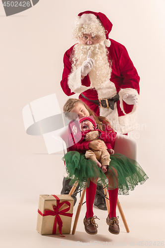 Image of Christmas portrait of cute little newborn baby girl, dressed in christmas clothes, studio shot, winter time