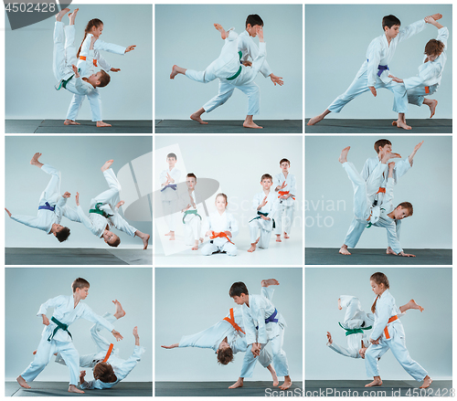 Image of The group of boys and girl fighting at Aikido training in martial arts school. Healthy lifestyle and sports concept