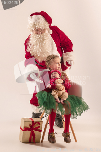 Image of Christmas portrait of cute little newborn baby girl, dressed in christmas clothes, studio shot, winter time