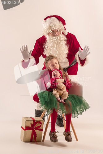 Image of Christmas portrait of cute little newborn baby girl, dressed in christmas clothes, studio shot, winter time