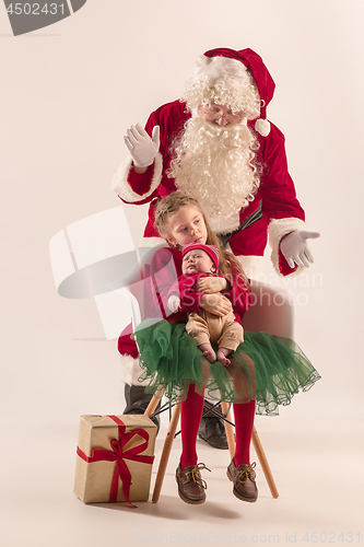 Image of Christmas portrait of cute little newborn baby girl, dressed in christmas clothes, studio shot, winter time