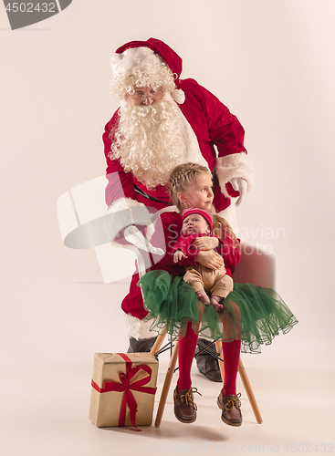 Image of Christmas portrait of cute little newborn baby girl, dressed in christmas clothes, studio shot, winter time