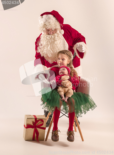 Image of Christmas portrait of cute little newborn baby girl, dressed in christmas clothes, studio shot, winter time