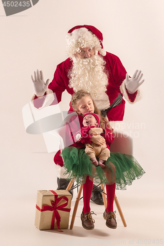 Image of Christmas portrait of cute little newborn baby girl, dressed in christmas clothes, studio shot, winter time