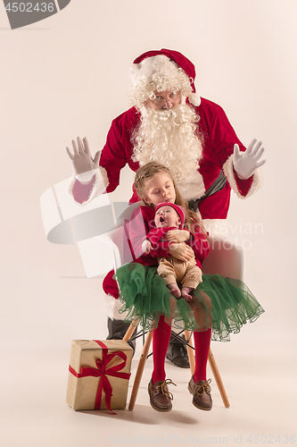 Image of Christmas portrait of cute little newborn baby girl, dressed in christmas clothes, studio shot, winter time