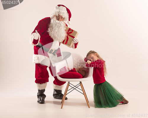 Image of Christmas portrait of cute little newborn baby girl, dressed in christmas clothes, studio shot, winter time