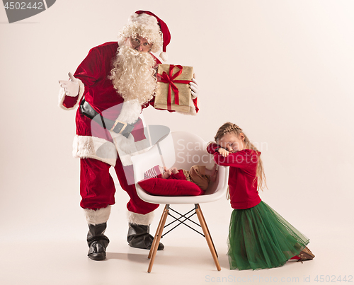 Image of Christmas portrait of cute little newborn baby girl, dressed in christmas clothes, studio shot, winter time