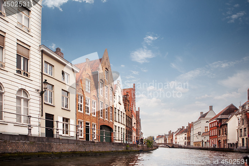 Image of view canal and colorful traditional houses against cloudy blue s