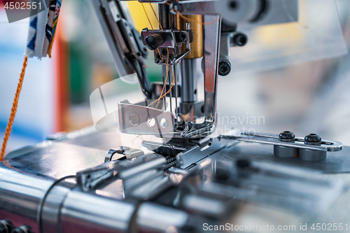 Image of Professional sewing machine close-up. Modern textile industry.