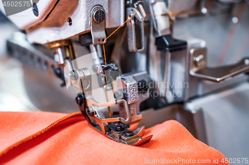 Image of Professional sewing machine close-up. Modern textile industry.