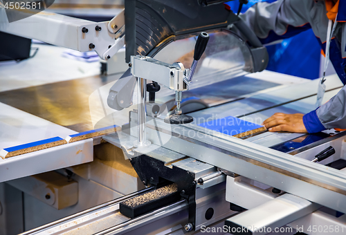 Image of Carpenter worker operating wood cutting machine. CNC woodworking