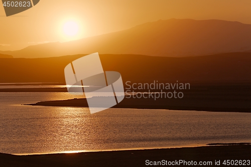 Image of Sunset with Lake and Hilly Landscape