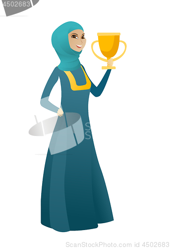 Image of Muslim business woman holding a trophy.