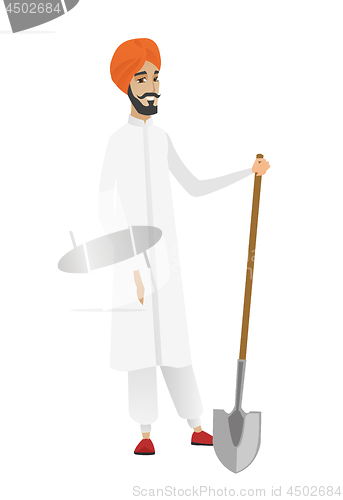Image of Young hindu farmer holding a shovel.