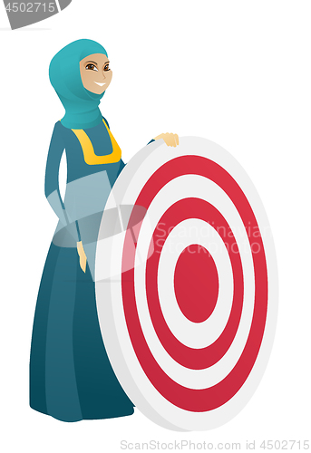 Image of Young muslim business woman and dart board.